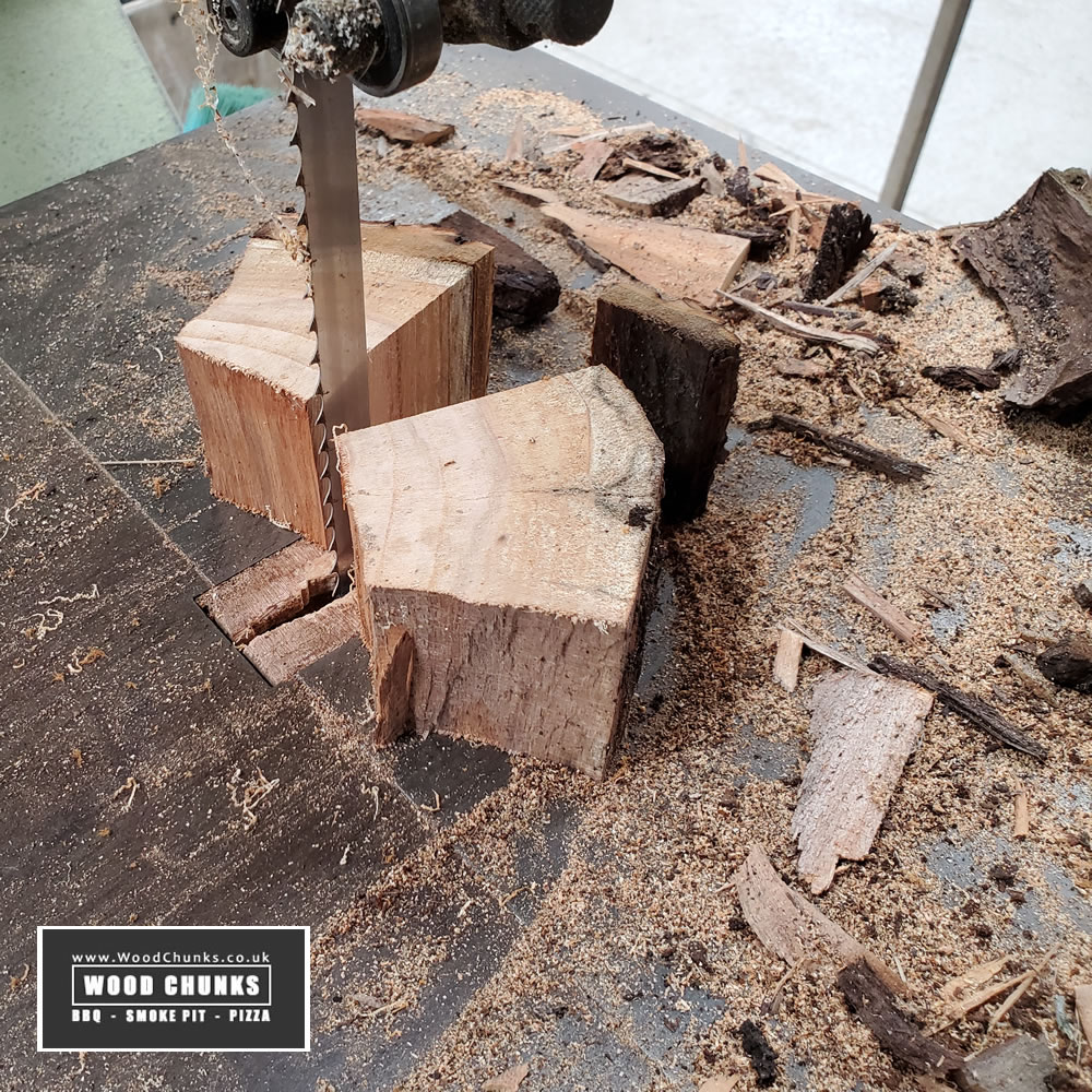 Bandsawing cherry logs into cherry wood chunks